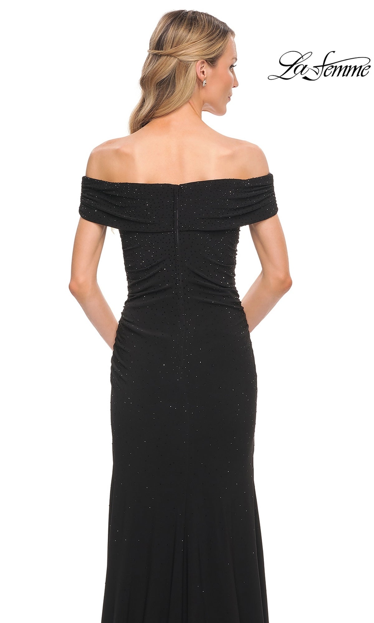 Back view of a woman wearing a La Femme 30117 floor-length black off-shoulder evening gown with subtle glitter detailing.